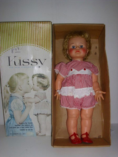 DOLL: IDEAL KISSY DOLL WITH BOX. ARM NEEDS RE-ATTACHING; MINOR STAINS ON LEGS; BOX FADED; STAINED. BOX MEASURES 10 1/2 INCHES X 6 INCHES X 24 1/2 INCHES. All property is sold "AS IS", "WHERE IS", and ALL SA