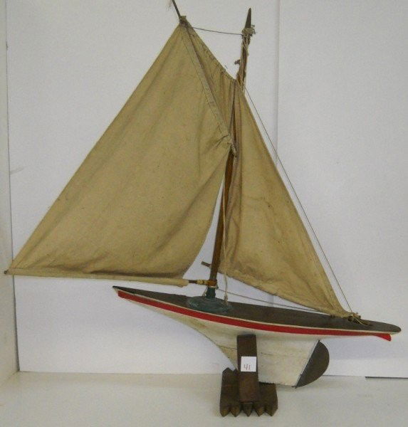 POND BOAT: LARGE WOOD POND SAIL BOAT. PAINT LOSS; SCRATCHES; PIECES LACKING; NEEDS SOME REPAIR. 34 INCHES HIGH X 26 1/2 INCHES LONG X 5 INCHES WIDE WITHOUT BASE. All property is sold "AS IS", "WHERE IS", and ALL