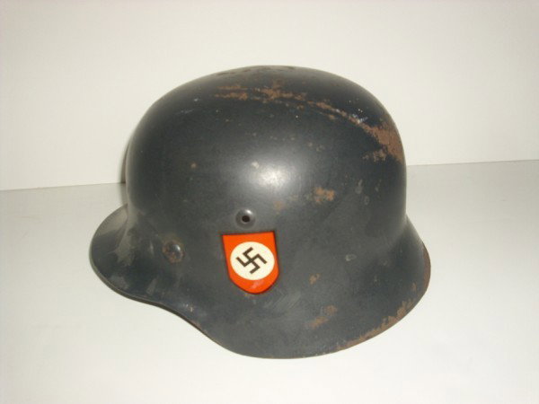 WWII HELMET: WW II NAZI MILITARY HELMET. POSSIBLE REPLACED STICKER. USED CONDITION; HAIRLINE CRACK ON SIDE. 11 INCHES X 9 1/2 INCHES.