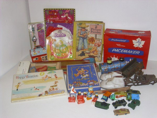 TOYS: ASSORTED TOY LOT INCLUDING PLAYART, HUSKEY, CORGI CARS/TRUCKS; SIZE 8 PACEMAKER ICE SKATES; JUNIOR KITCHEN SET; KING PIN JR.; BETTY BOOP CLOTHES. LACKING PIECES; SOME USED CONDITION.