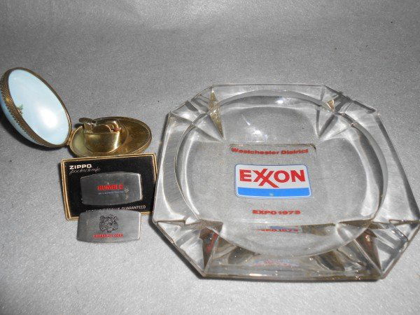 ASSORTED LOT: 4 PIECES ASSORTED LOT INCLUDING EXXON WESTCHESTER DISTRICT EXPO 1973 ASHTRAY; ZIPPO HUMBLE POCKET KNIFE IN ORIGINALL BOX; EGG SHAPED LIGHTER MARKED EVANS; RINKER OIL CORP. POCKET KNIFE. USED CONDITION