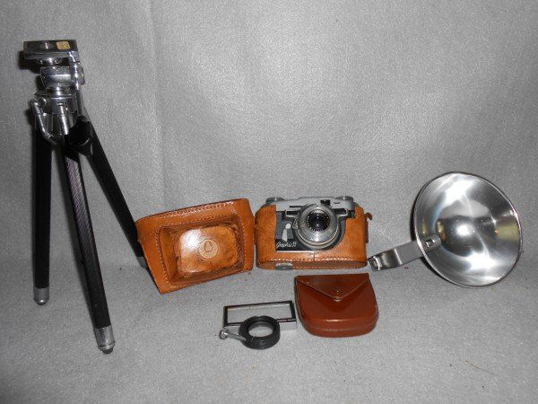 CAMERA: CAMERA LOT INCLUDES TRIPOD; GRAFLEX PROXIMETER WITH CASE; GRAFLEX GRAPHIC 35 CAMERA; GRAFLASH. CAMERA CASE WORN, LACKING STRAPS. LARGEST MEASURES 12 INCHES.