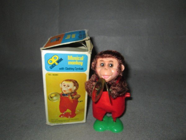 TOY: MUSICAL MONKEY WITH CLASHING CYMBALS MADE IN HONG KONG. BOX TORN. 6 INCHES X 3 1/2 INCHES.