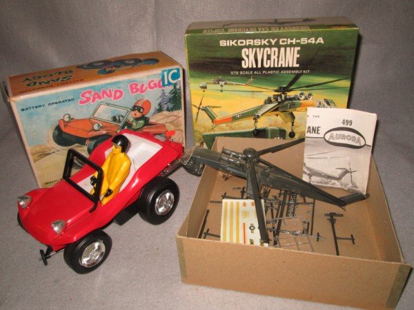 TOYS: TOY LOT INCLUDING AURORA SIKORSKY CH 54A SKYCRANE MODEL KIT 1969; BATTERY OPERATED SAND BUGGY. MODEL KIT NOT COMPLETE; BUGGY PIECES NOT ATTACHED. 12 INCHES X 7 1/2 INCHES