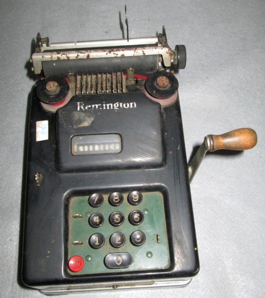 ADDING MACHINE: REMINGTON RAND ADDING MACHING. LACING BUTTONS; SCRATCHES USED CONDITION. 12 INCHES X 6 1/2 INCHES.