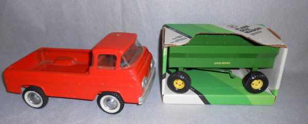 TOYS: 2 TOY TRUCK INCLUDING ERTL JOHN DEER FLARE BOX WAGON IN ORIGINAL BOX; & NY-LINT FORD TRUCK. GLASS CRACKED; SCRATCHES; DENT. LARGEST MEASURES 5 INCHES X 3 INCHES.