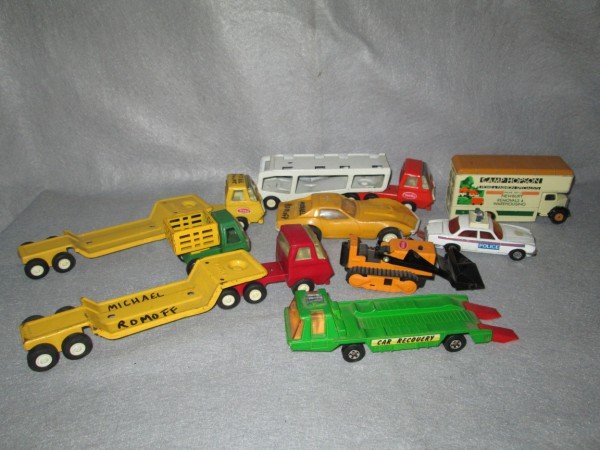 TOYS: 7 TOY CARS INCLUDING MATCHBOX; TONKA; BUDDY L; 2 PLASTIC CARS. WRITTEN ON; USED CONDITION; SCRATCHES.