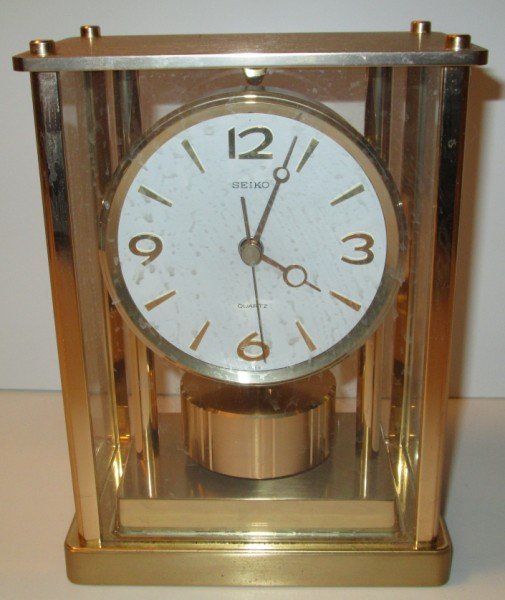 CLOCK: SEIKO QUARTZ CLOCK. NOT GLASS. 6 1/2 INCHES X 8 1/2 INCHES X 4 INCHES.