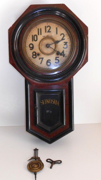 CLOCK: SEIKOSHA WALL HANGING REGULATOR CLOCK. SCRATCHES; EDGES SEPARATING; STAINS. 22 INCHES X 13 INCHES.