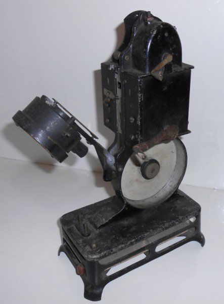 MOVIE PROJECTOR: 1920'S PATHEX FRENCH HAND CRANK MOVIE PROJECTOR. LACKING PLUG. USED CONDITION. 13 INCHES X 7 INCHES.