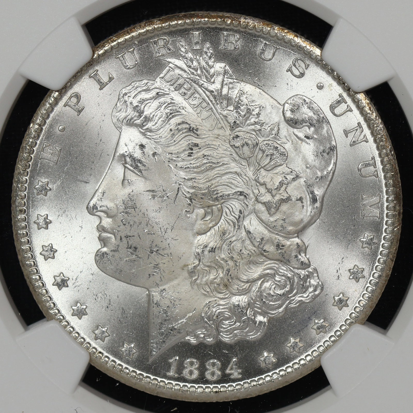 1884 CC Morgan Silver Dollar NGC MS-63 NEAR PL: Frosty devices and nearly liquid fields on both sides. CAC candidate for sure!