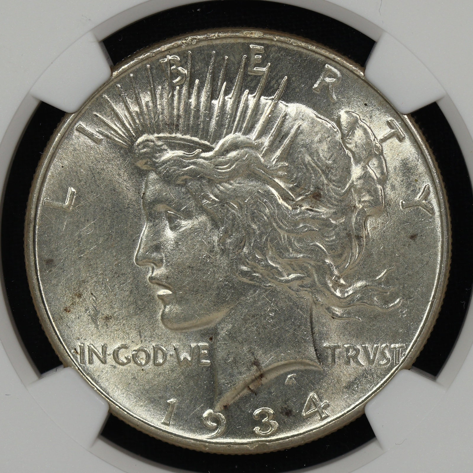1934 Peace Silver Dollar NGC UNC Better Date: Almost imperceptable cleaning. Very light hairline marks on the cheek and neck. Would be MS-63 otherwise.
