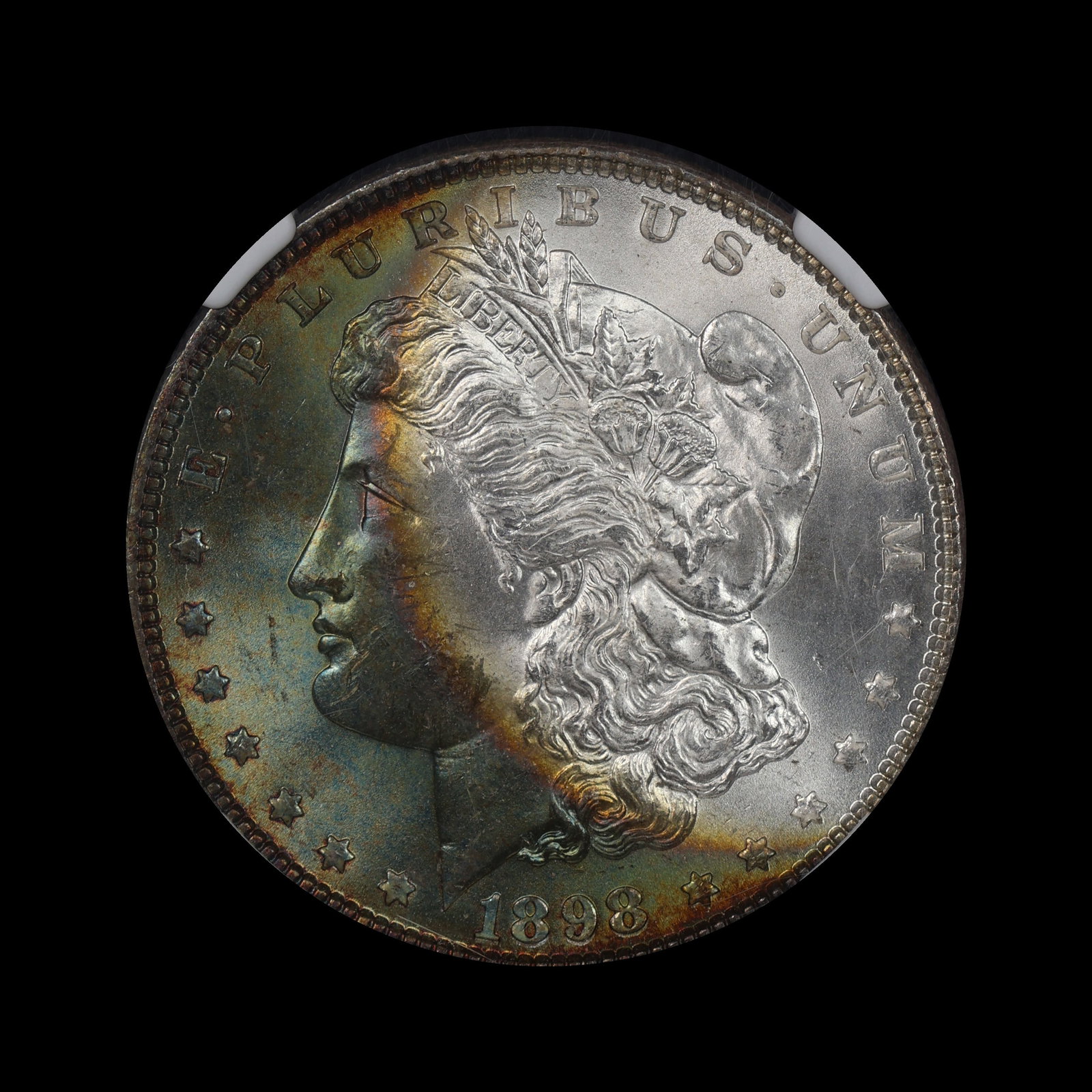 1898 Morgan Silver Dollar NGC MS 63 MONSTER TONED: (ZRTZ) Gorgeous crescent toning with elusive colors perched perfectly on the profile.