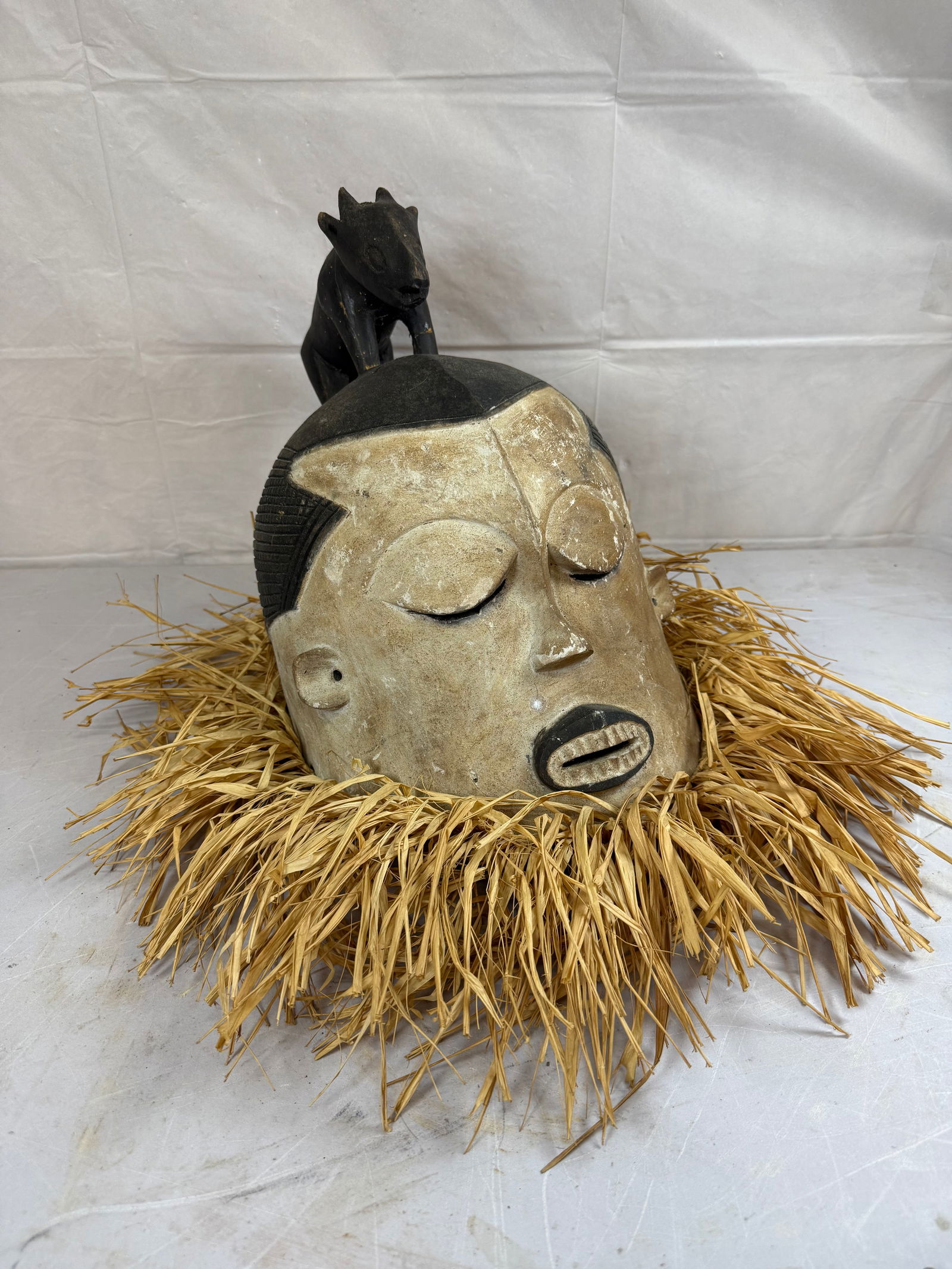 Hand Carved Wooden and Raffia Straw African Mask: Hand Carved Wooden and Raffia Straw African Mask, Has Animal On Top of Head