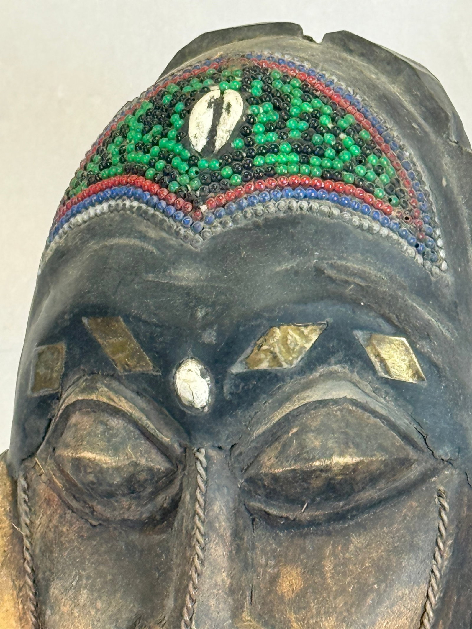 Hand Carved Wooden African Sculpture: Hand Carved Wooden African Sculpture Has Beading on Top