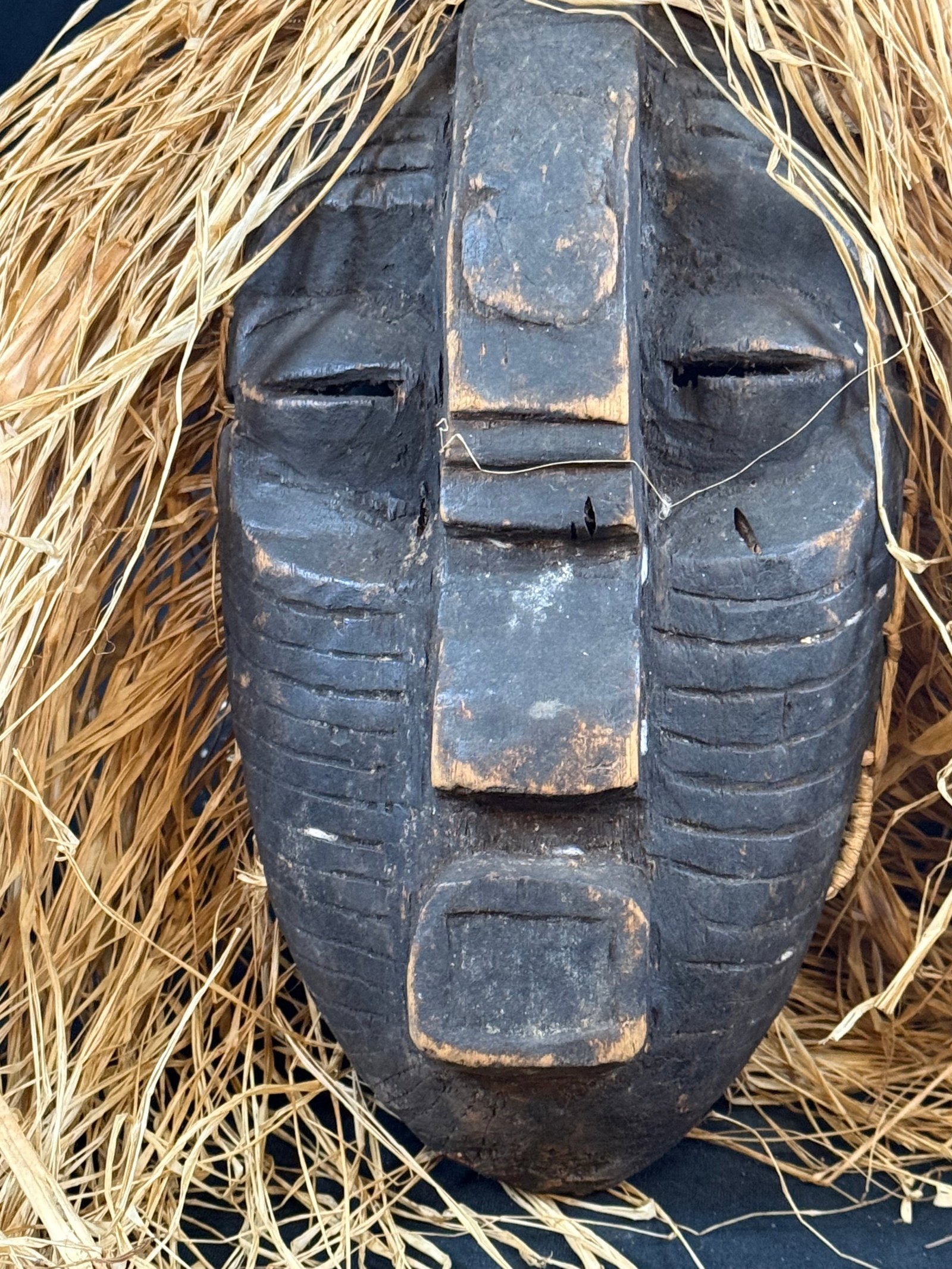 Hand carved wooden African mask w/raffia straw: Hand carved wooden African mask w/raffia straw
