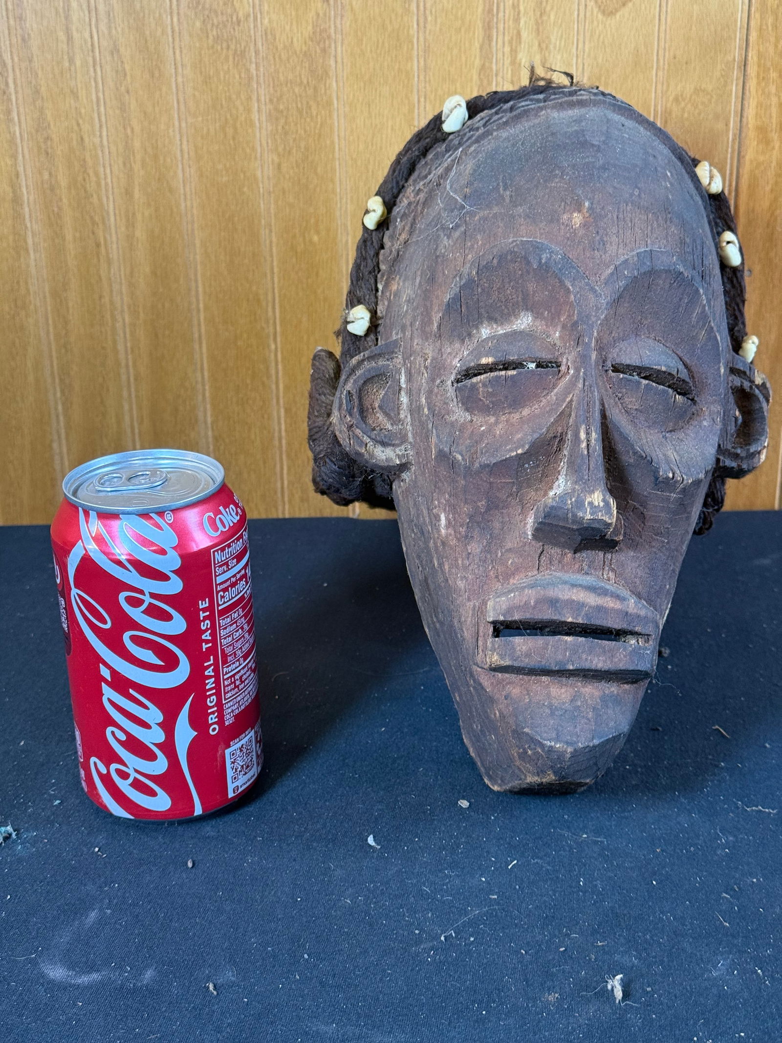 Hand carved wooden African mask w/yarn hair: Hand carved wooden African mask w/yarn hair. Decorated with shells