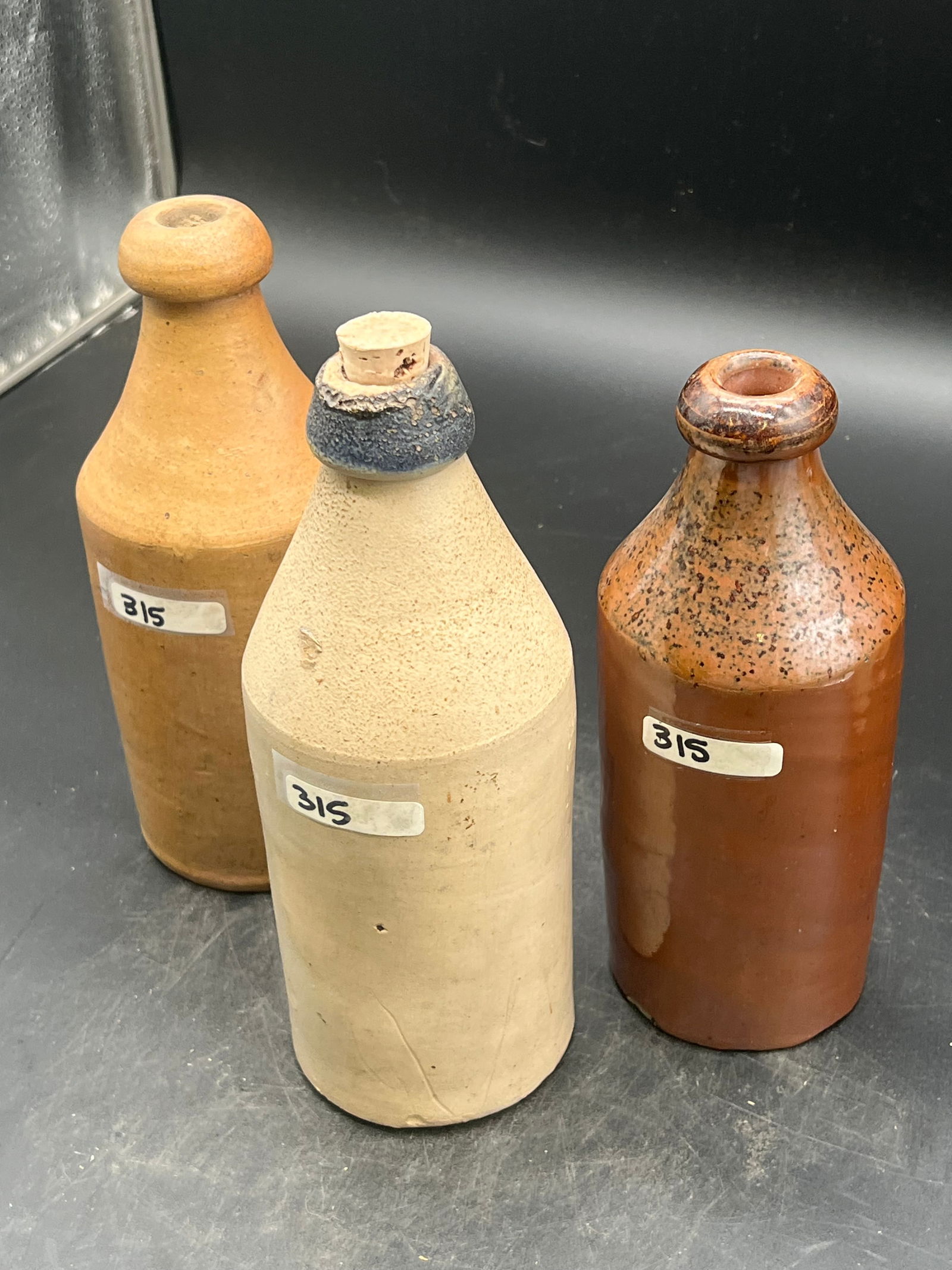 Lot of 3 Stoneware Bottles: Lot of 3 Stoneware Bottles (61,65,65?)
