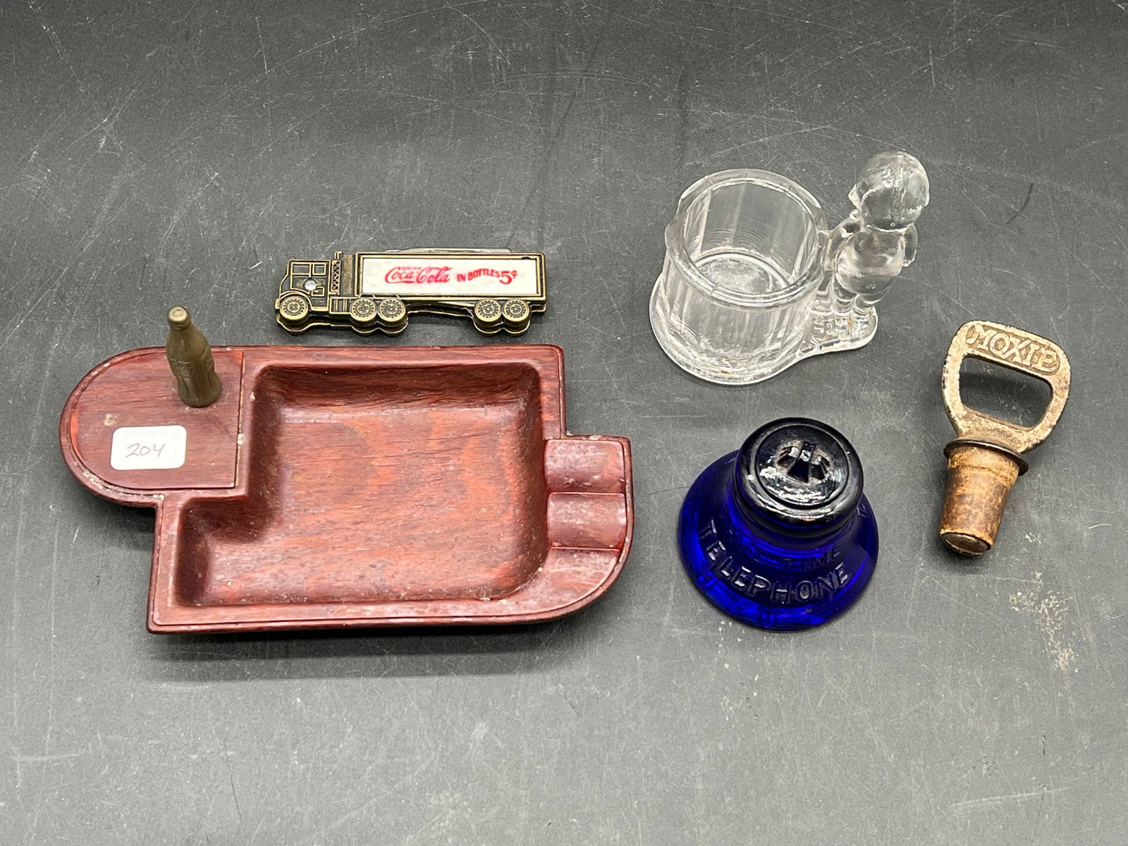 Lot of 5 Early Collectibles: Lot of 5 Early Collectibles. Coca Cola pocket knife, Coca Cola Ashtray, Save Time Bell, Moxie Metal Cork, and Kewpie shot glass