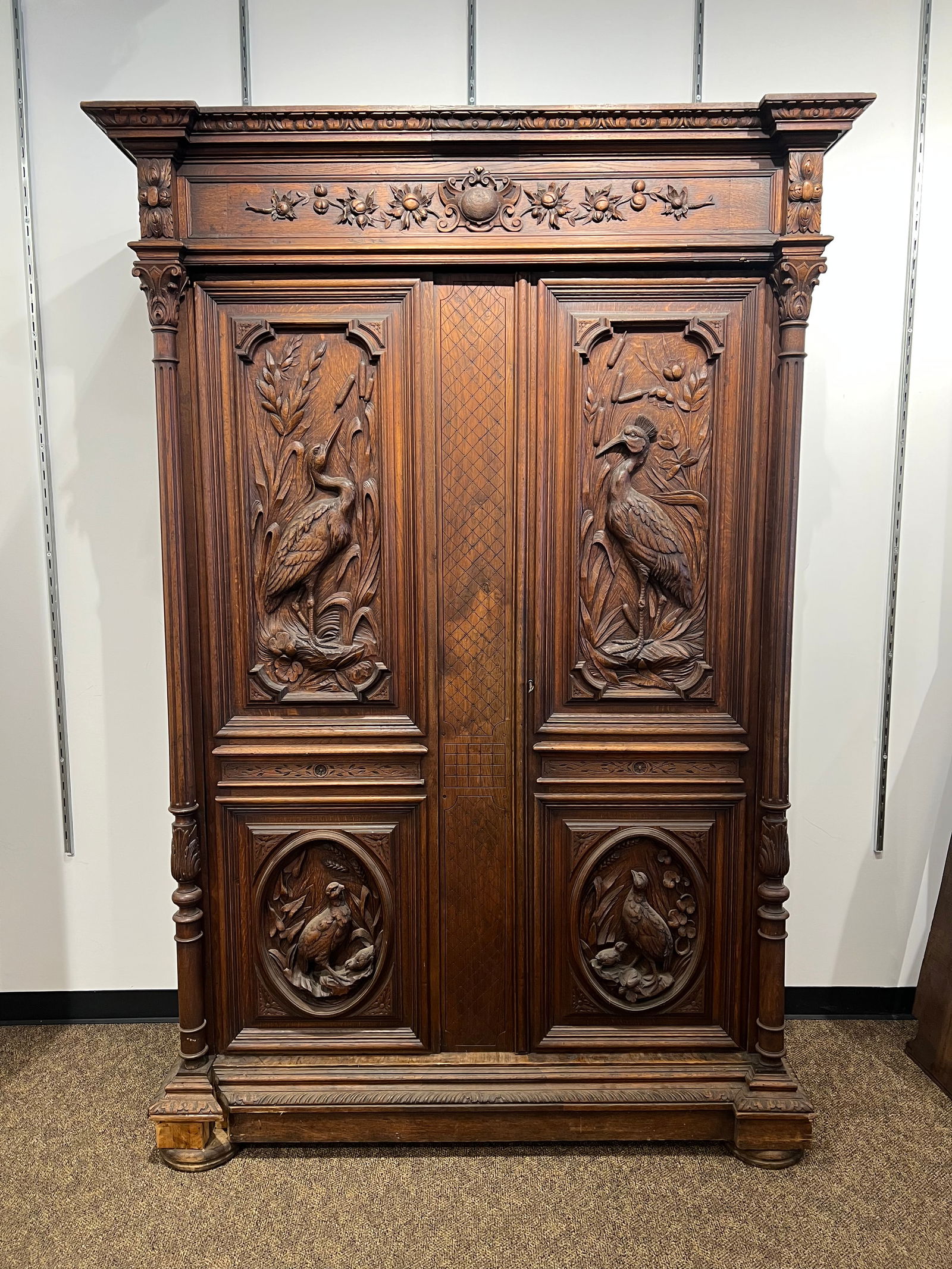 Walnut 2 door linen press with massive carvings.: Walnut 2 door linen press with massive carvings. Has 3 shelves. original finish. bottom mounlding has been repaired. comes apart for easy transport. 8 pieces.