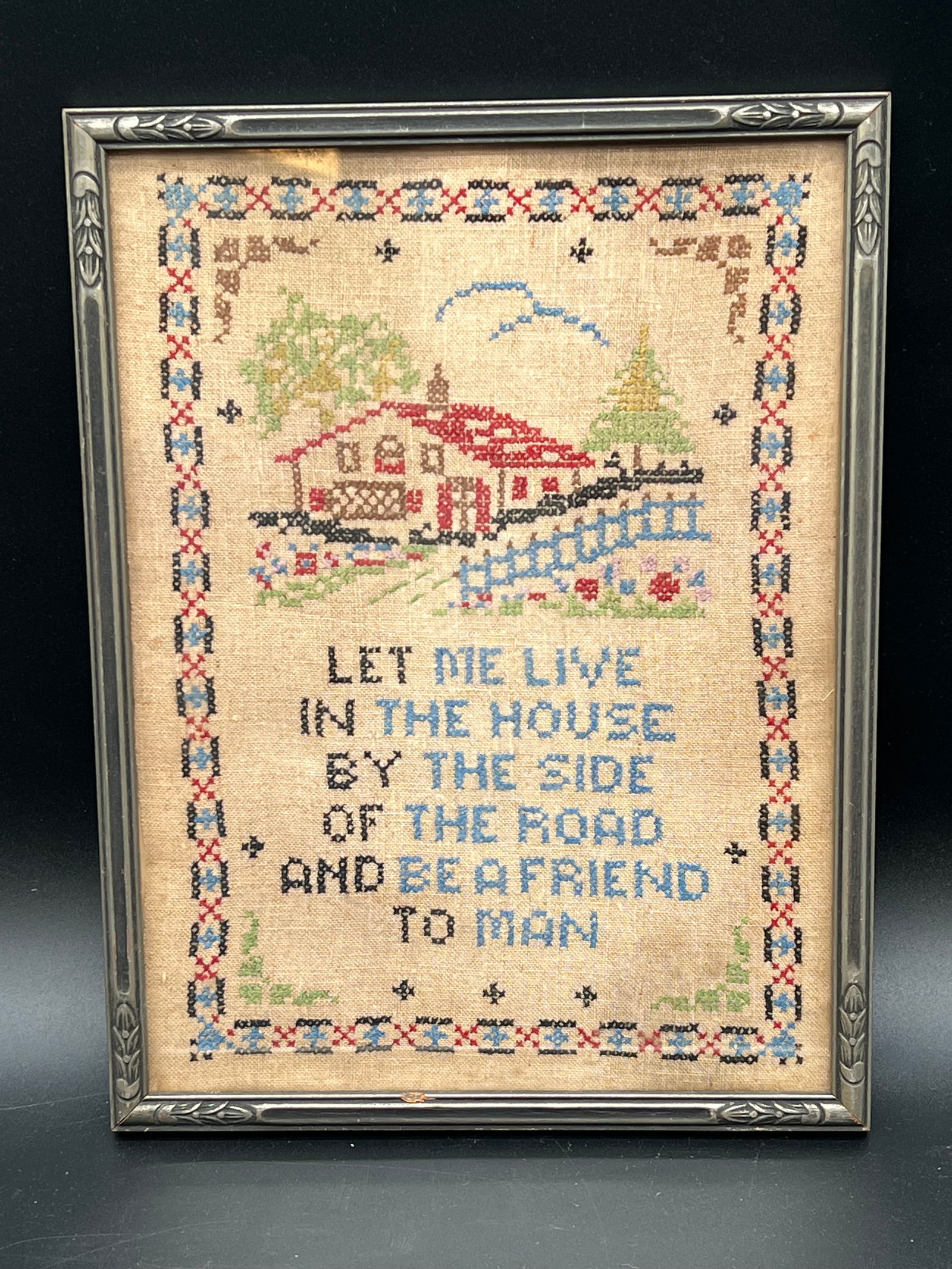 Early Needlepoint in Frame: Early Needlepoint in Frame. “Let me live in the house by the side of the road and be a friend to man”