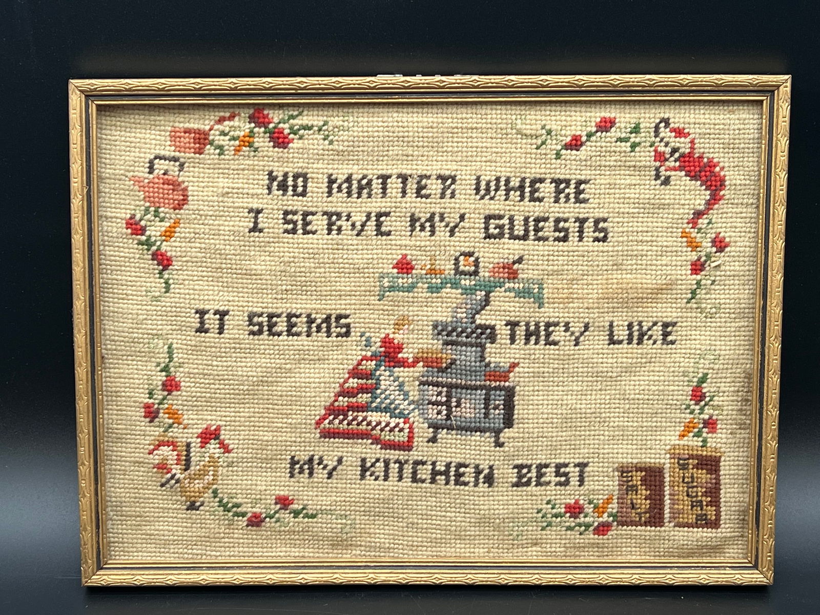 Early Needlepoint in Frame: Early Needlepoint in Frame. Does not have glass. “No matter where I serve my guests it seems they like my kitchen best”