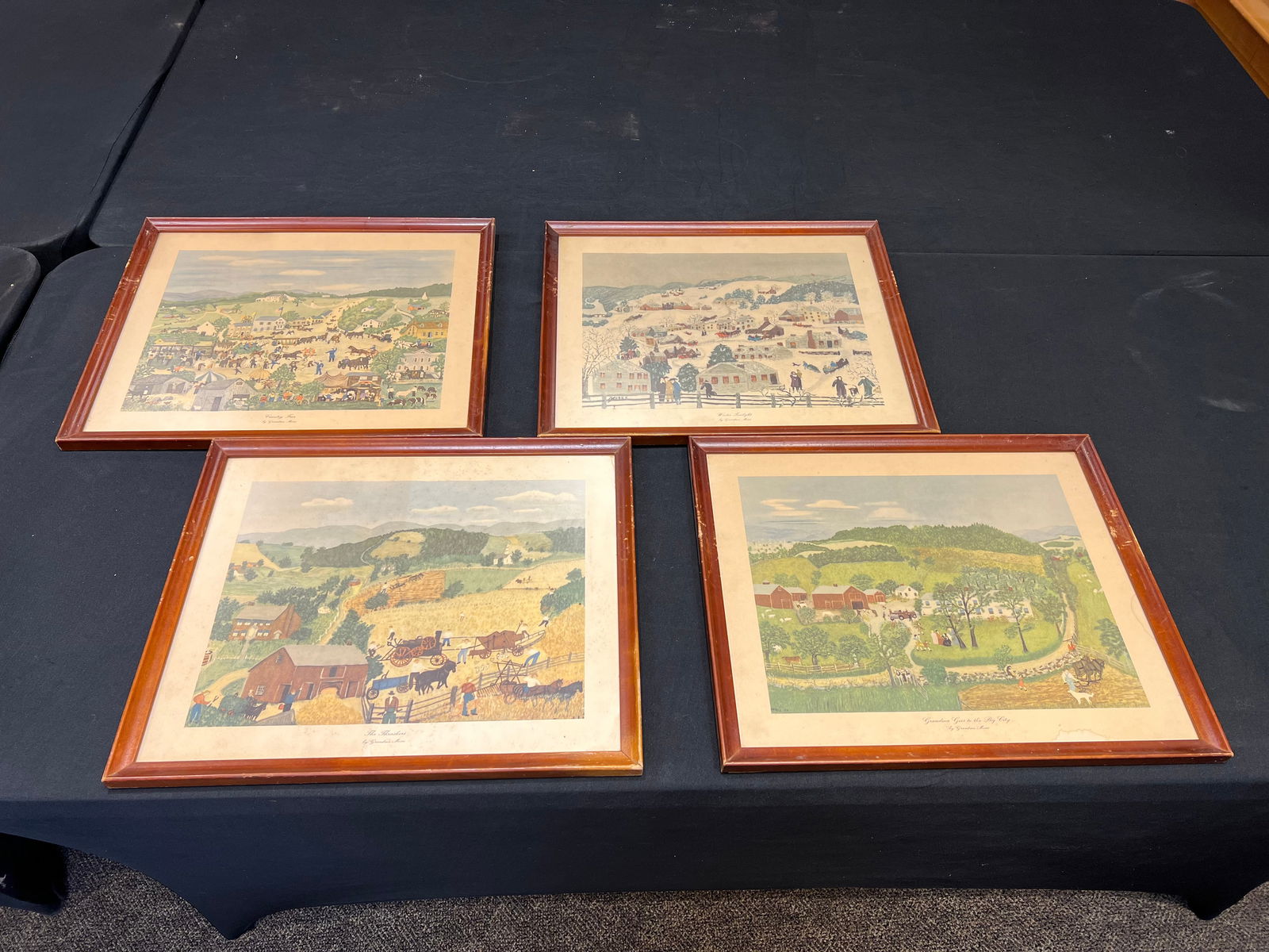 Lot of 4 Prints by Grandma Moses: Lot of 4 Prints by Grandma Moses. “Winter Twilight”, The Thrashers”, “Grandma goes to the big city”, an d “Country Fair”