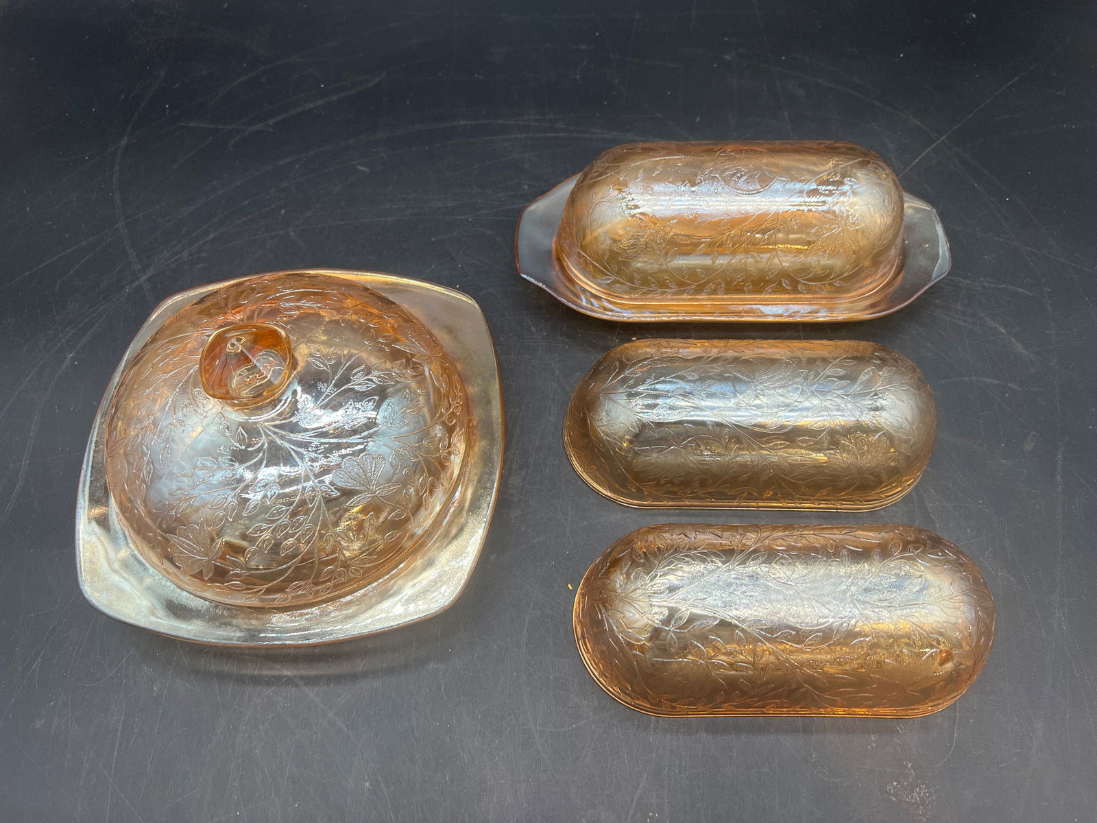 Lot of 4 pc. Carnival Glass Dishes: Lot of 4 pc. Carnival Glass Dishes. Jeanette Floragold - Iridescent Pattern. Butter dish, 2 butter dish lids, and butter dish with lid