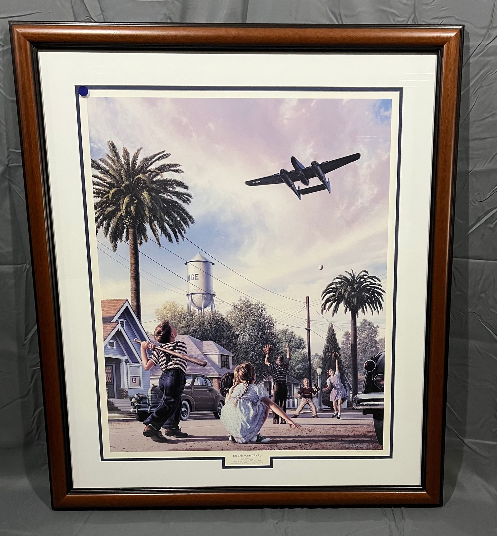 Signed Stan Vosburg Framed Aviation Print: Signed Stan Vosburg Framed Aviation Print. In modern frame. Features a nostalgia town scene with twin-engine aircraft flying overhead. Has certificate of authenticity