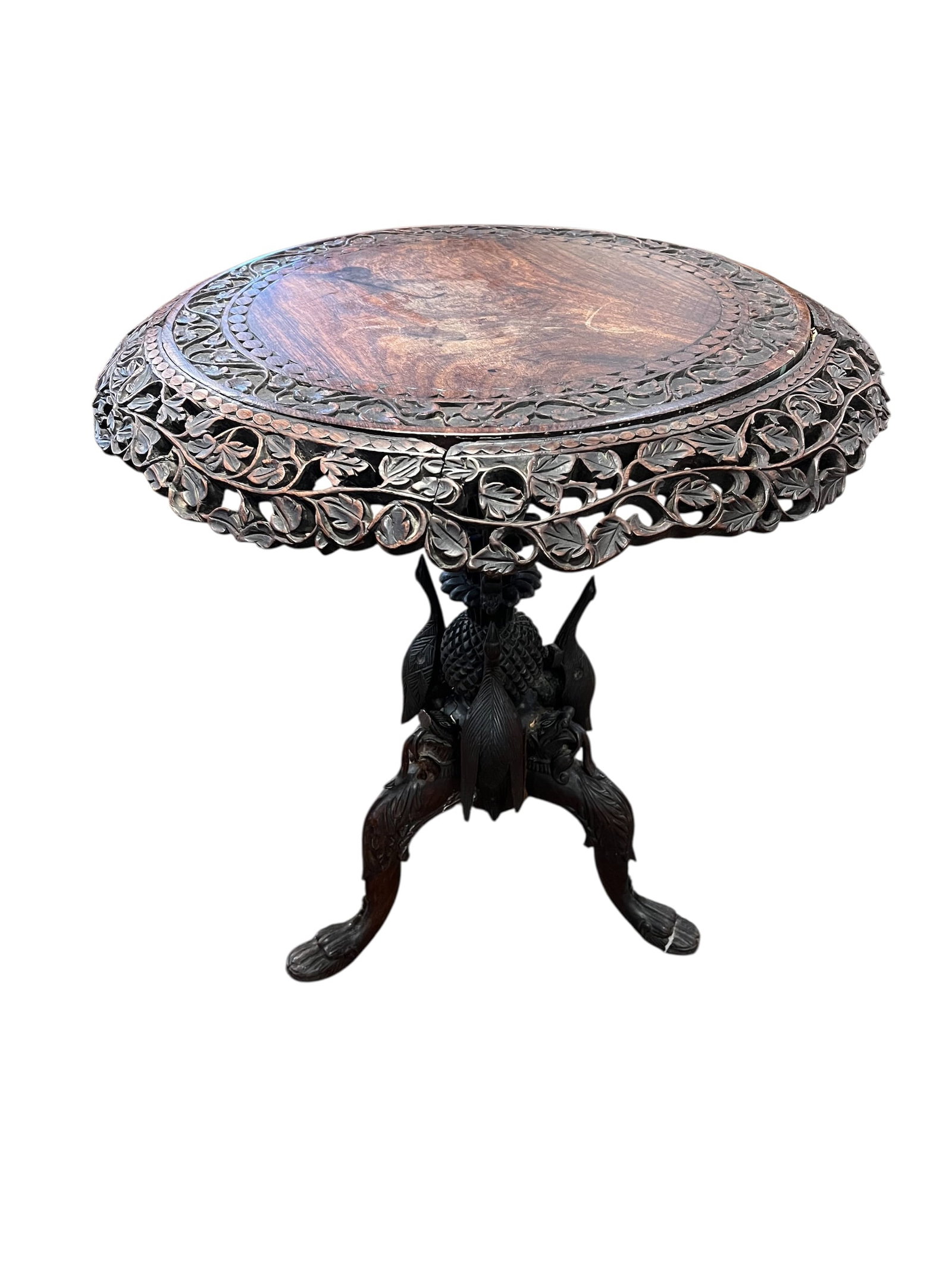 Rosewood Black Forest Engraved Tilt Top Table.: This is a 19th-century Burmese hand-carved hardwood side table with a circular top featuring relief-carved foliage and mythical animal motifs. [1, 2]Intricate Design: The table is known for profuse, d