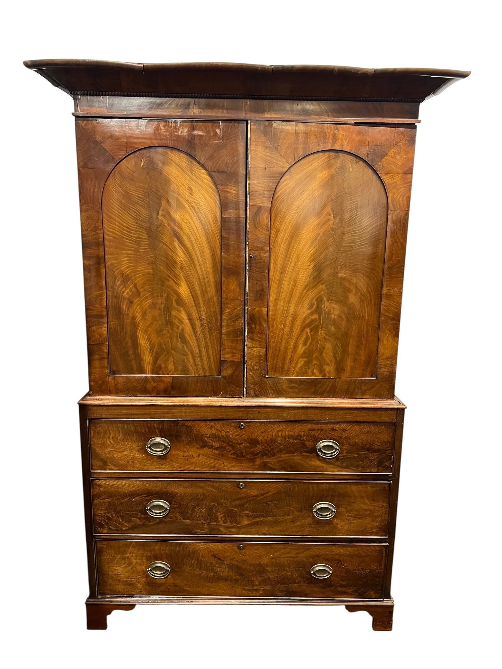Georgian Style Mahogany Linen Press: This is a George III mahogany linen press, typically featuring flame mahogany veneer on the arched upper panels and a lower case with graduated drawers. [1, 2]Design and Materials: These pieces are ge