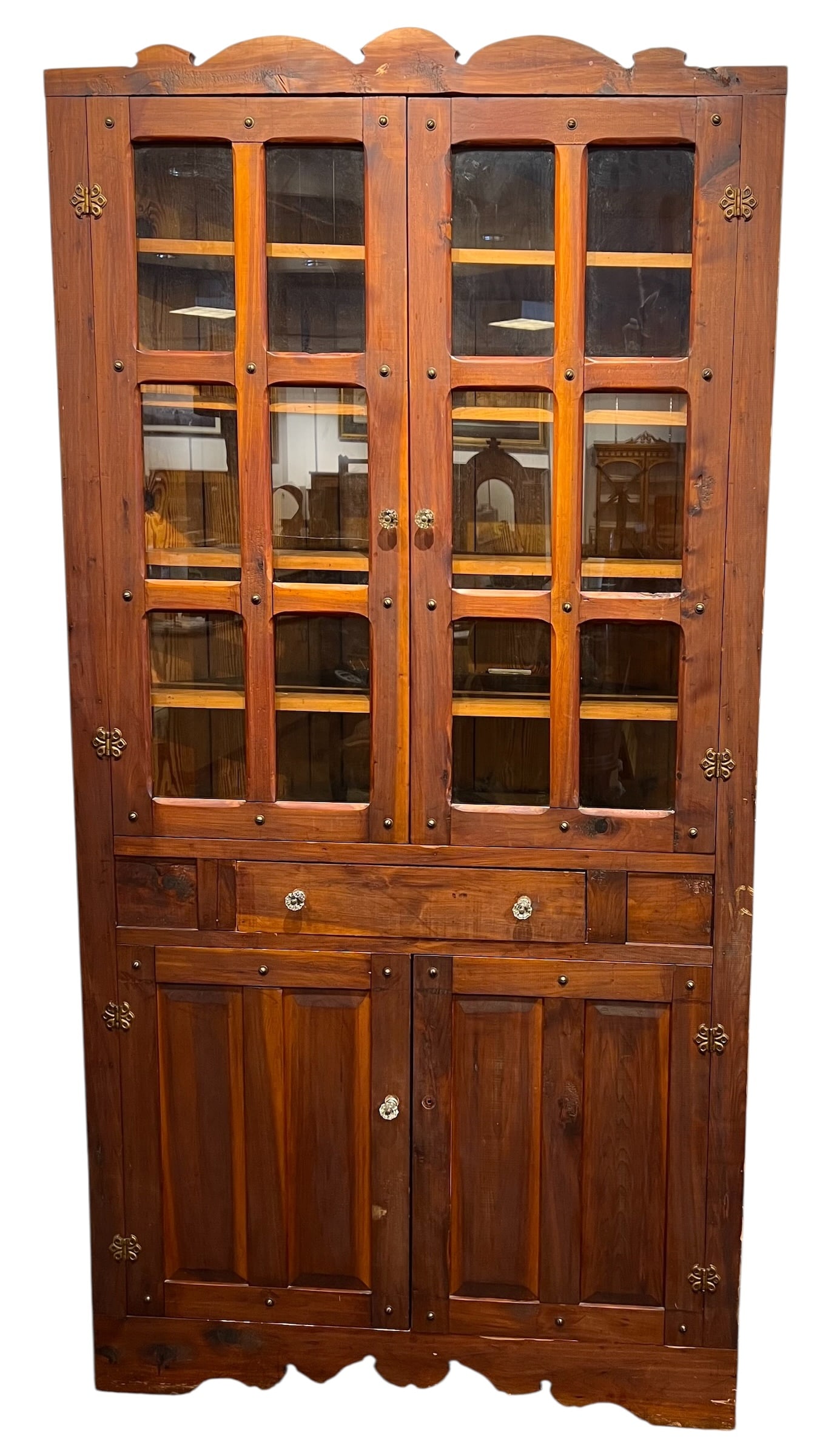 Rustic Hutch with Glass Pane Top: Rustic Hutch with Glass Pane Top. This is a rustic wooden cabinet with glass doors and intricate hardware.This piece features a two-part design, likely a corner cabinet, with paneled glass doors in