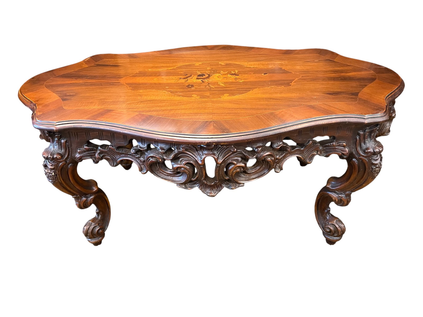 Vintage Intricate Carved Coffee Table: This ornate table is characteristic of Rococo Revival or Louis XV style, typically crafted from walnut or mahogany and dating from the late 19th to early 20th century. It features a heavily carved apr
