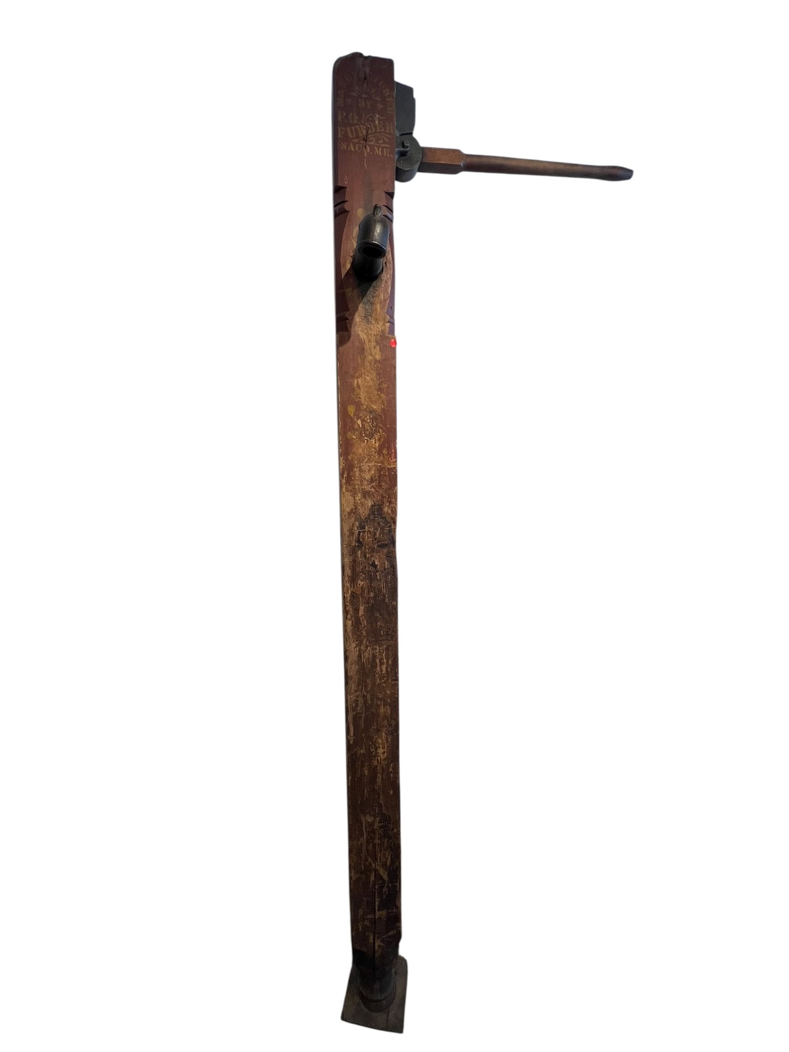 Early Water Pump: The object is a wooden hand water pump, similar to a salesman sample.It is constructed from wood and features metal hardware, often with stenciling.These vintage tools are sometimes mounted on stands 