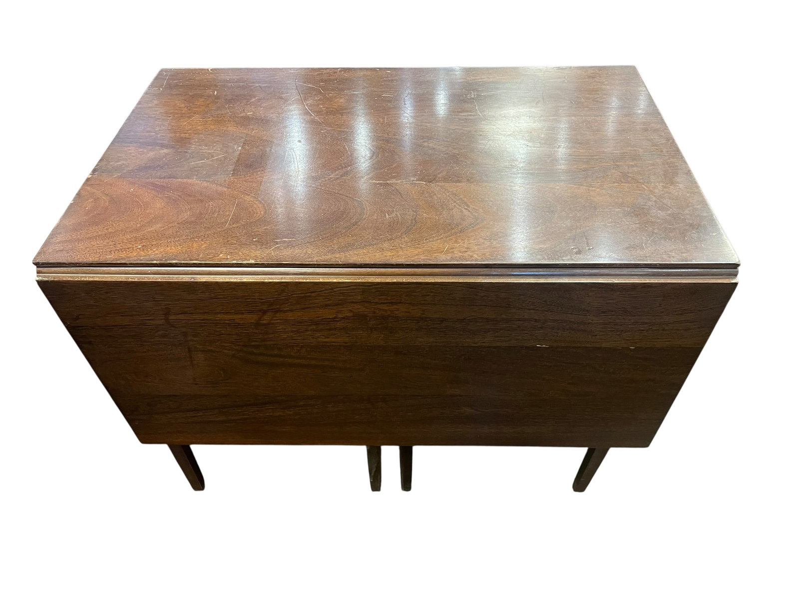 Walnut Dropleaf Table: This item is a vintage Mid-Century Modern drop-leaf dining table, featuring a clean-lined rectangular top, collapsible side leaves, and tapered wooden legs. It is constructed from a rich hardwood