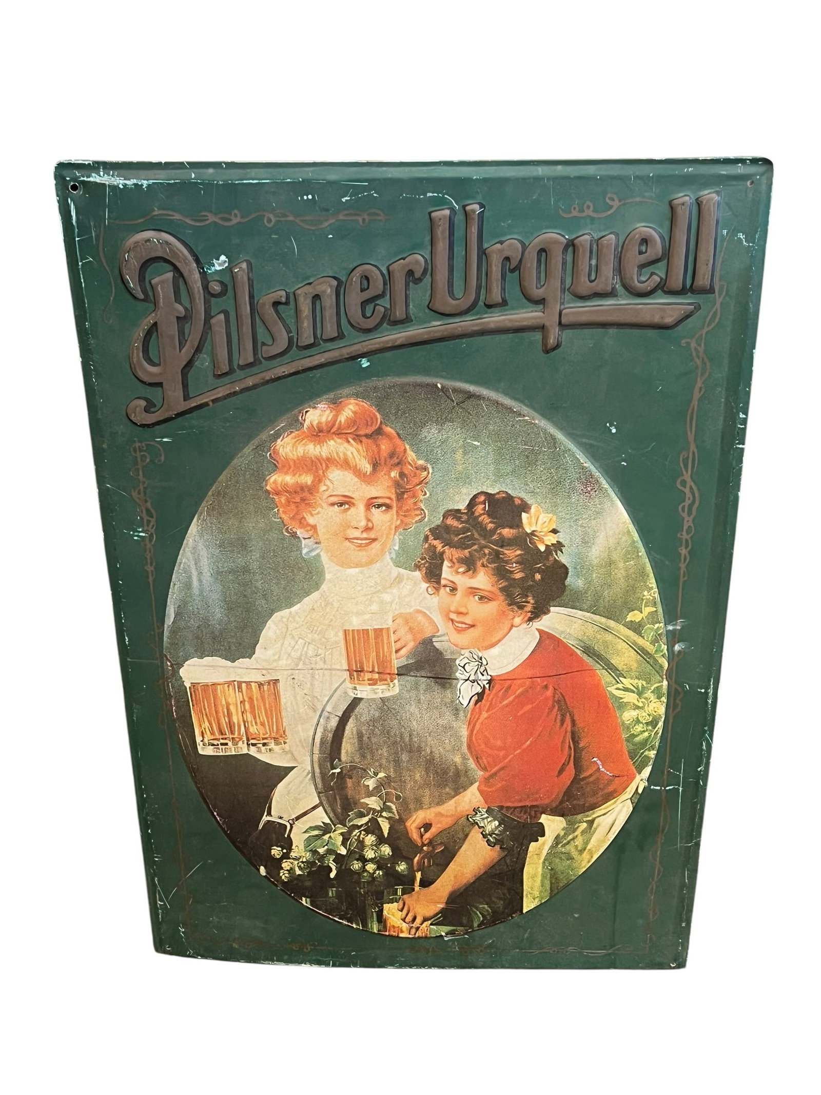 PilsnerUrquell Metal Advertising Sign: This is a vintage-style Pilsner Urquell metal advertisement sign.Design: Features Art Nouveau-inspired artwork of two women serving beer from a wooden keg.Material: Constructed from sheet steel, often