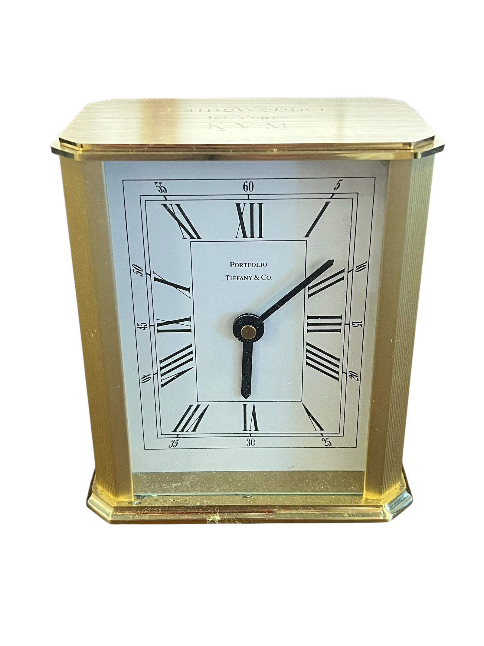 Tiffany & Co Brass Clock: This item is a vintage Tiffany & Co. Portfolio Brass Quartz Desk Clock, originally produced in Germany. It features a heavy, solid brushed brass rectangular case, a white dial with classic black