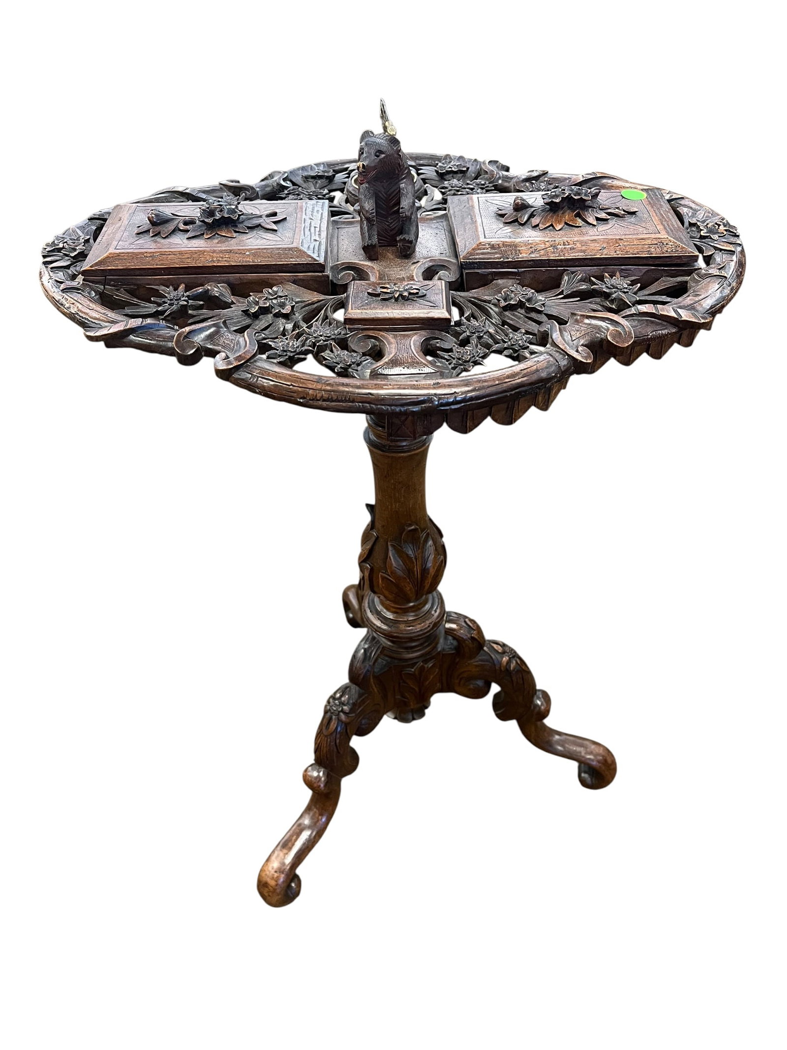 Black Forest Smoking Stand: This item is an antique Swiss Black Forest smoking table (often called a smoker's stand or compendium), typically crafted from walnut or linden wood during the late 19th century (circa 1880–1900).