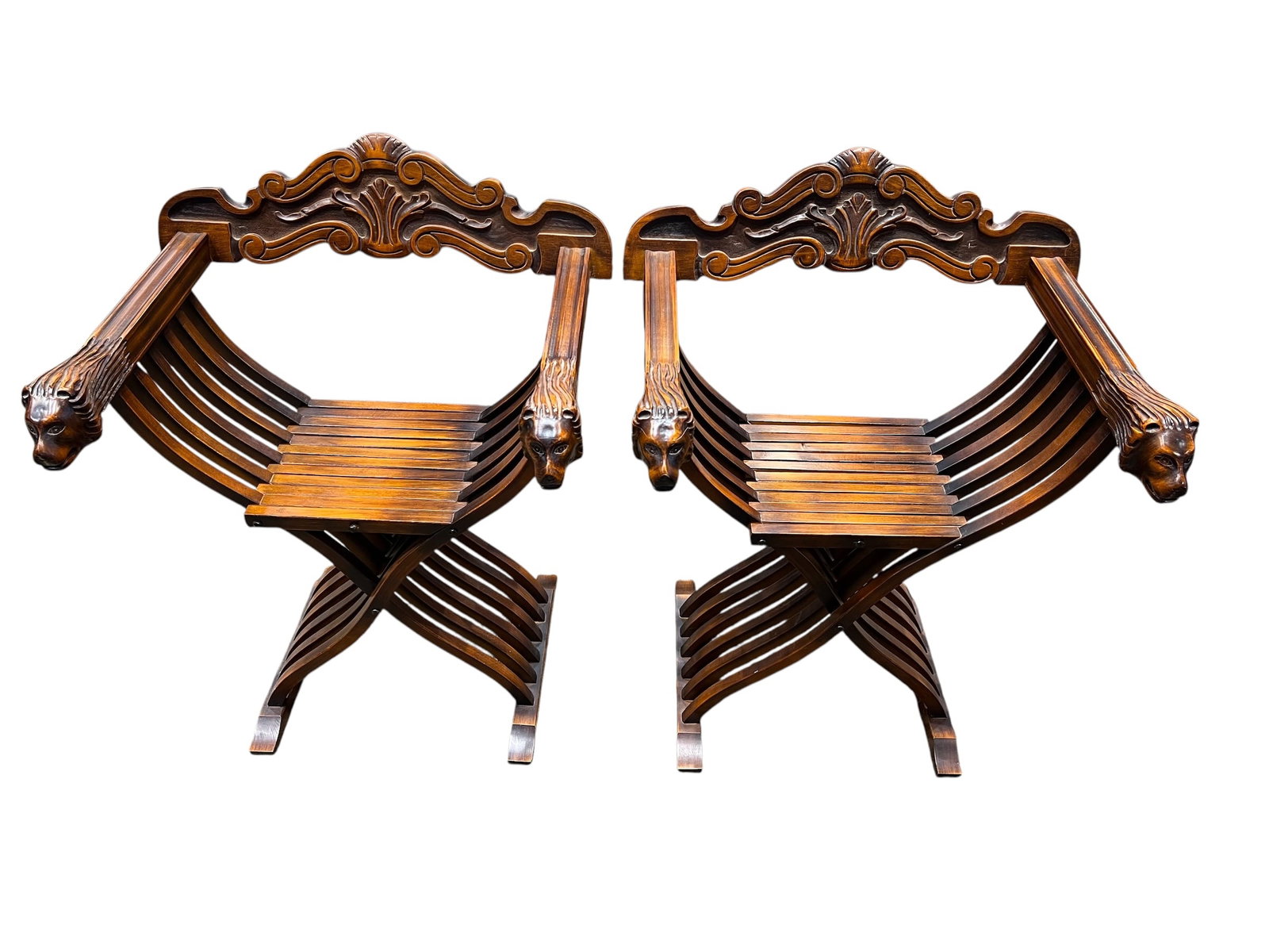 Pair of Italian Savonarola Folding Armchairs: This is a vintage Italian Savonarola-style folding chair featuring carved lion head armrests and an X-frame design. [1, 2]Style: Renaissance Revival, characterized by ornate carving and historical