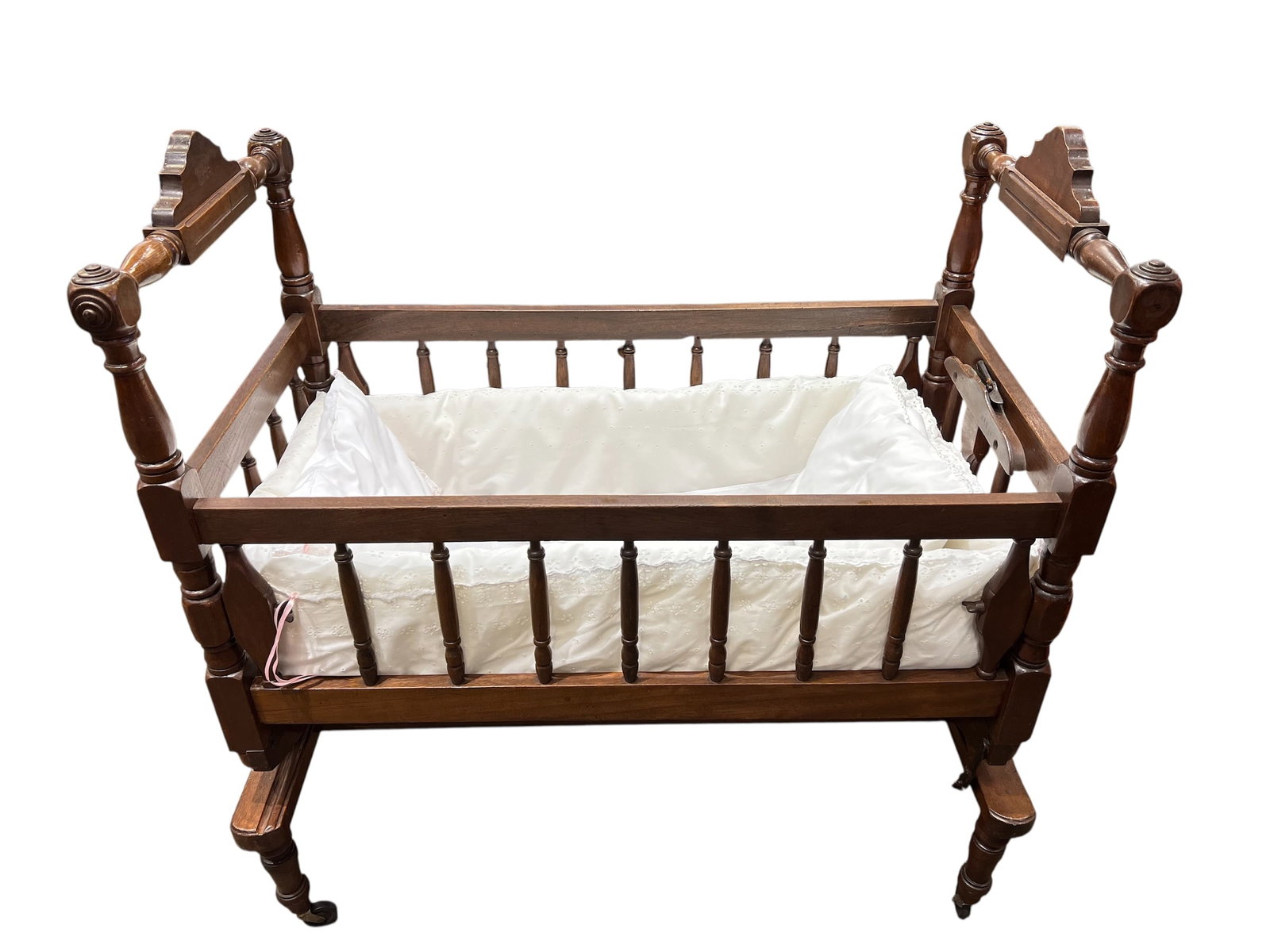 American antique Sheraton-style mahogany swinging baby cradle: This is an American antique Sheraton-style mahogany swinging baby cradle from the early-to-mid 19th century. [1, 2]Design: Features high, carved posts, canted sides, and a rocking mechanism supported