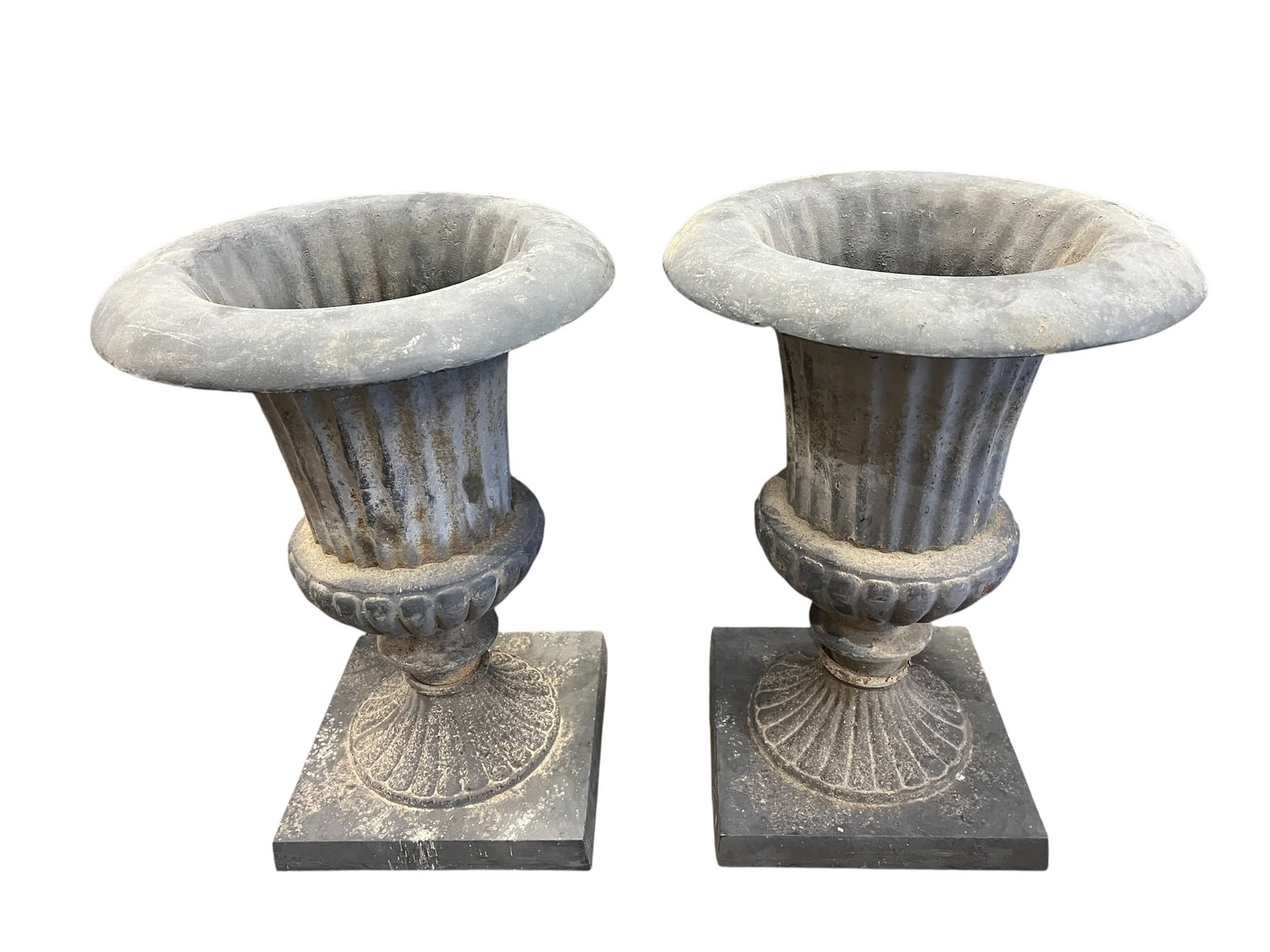 Pair of Cast Iron Planters: These are French Neoclassical cast iron garden urns often used as planters. [1]Style and Era: These urns feature a traditional Neoclassical design inspired by European vintage styles.Construction: The