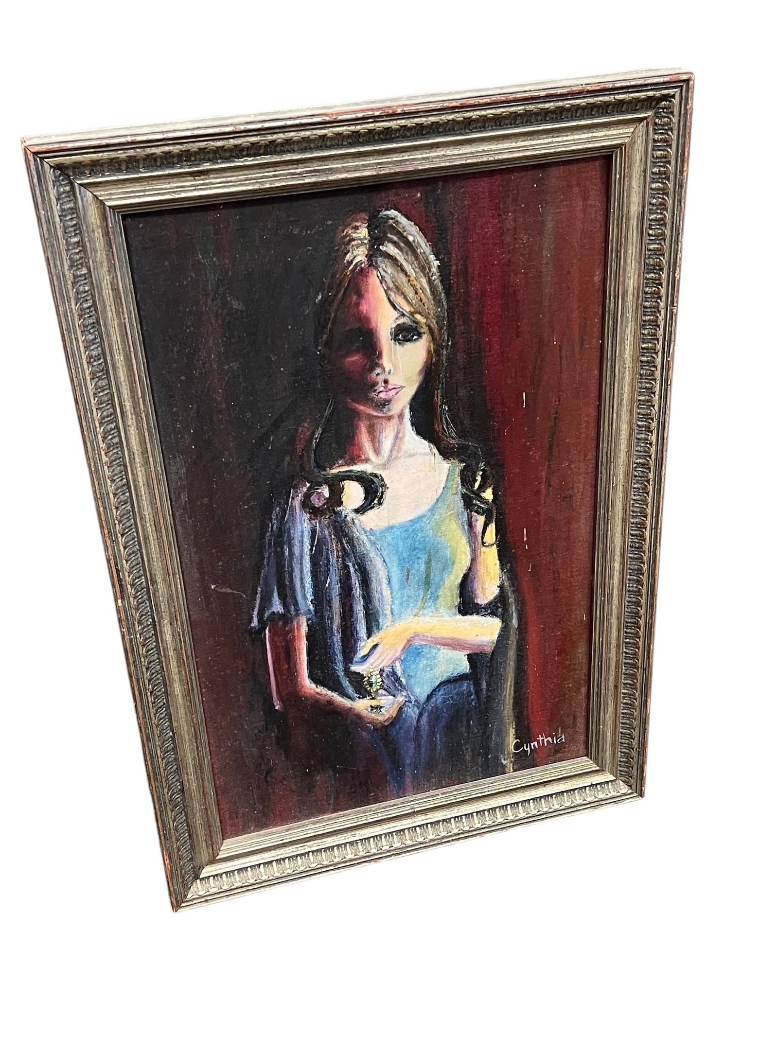 Vintage Style Painting of Woman Holding Object: This artwork appears to be a vintage "big eye" painting from the 1960s, a style popularized by artists like Margaret Keane. [1, 2]Artist Style: The painting features a subject with large, soulful
