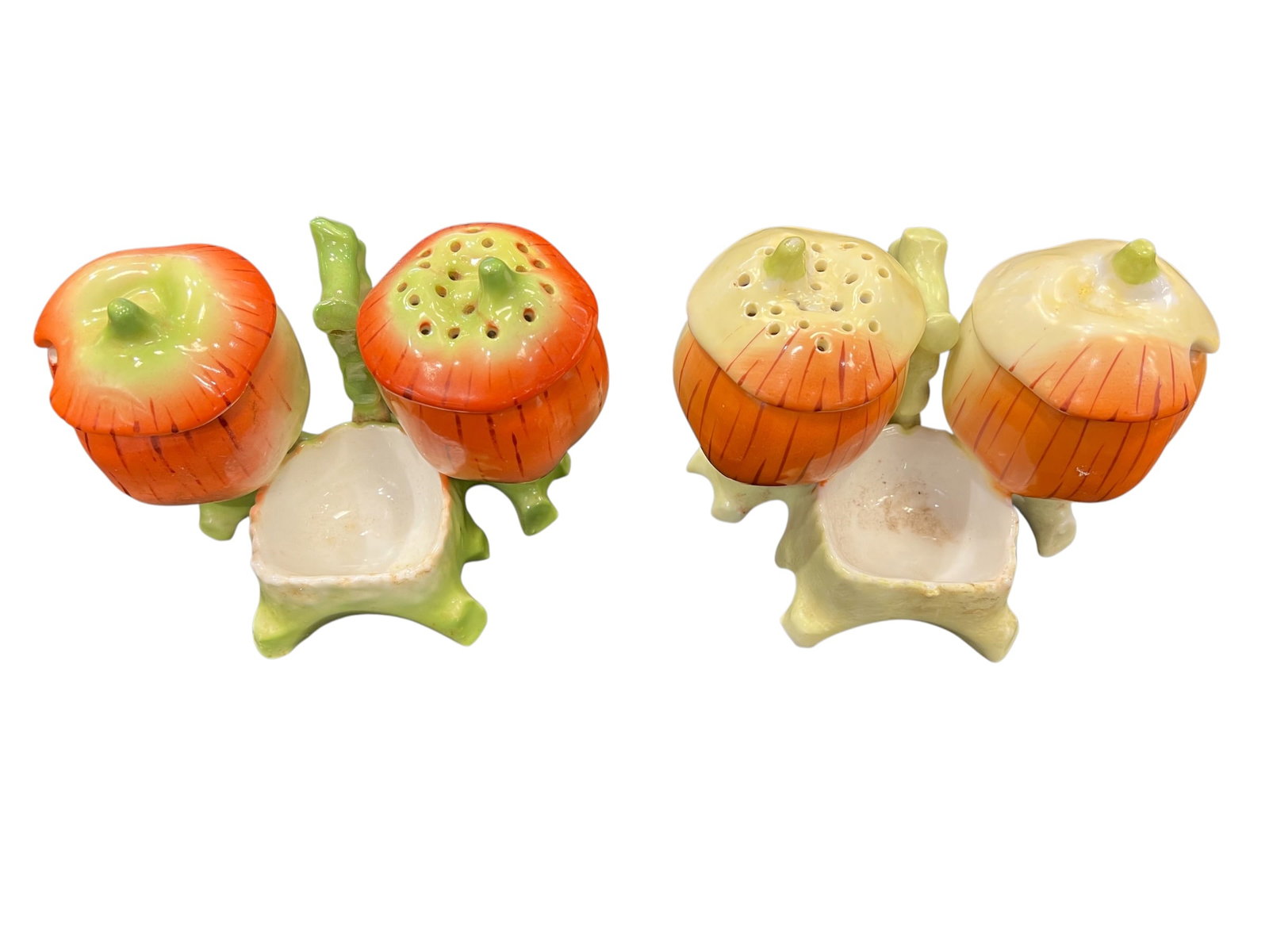 Lot of 2 Condiment Dishes: This image shows two mid-century vintage ceramic condiment sets designed in a rustic, figural garden theme. [1]Design DetailsComponents: Each individual three-piece cruet set contains a multi-holed pe