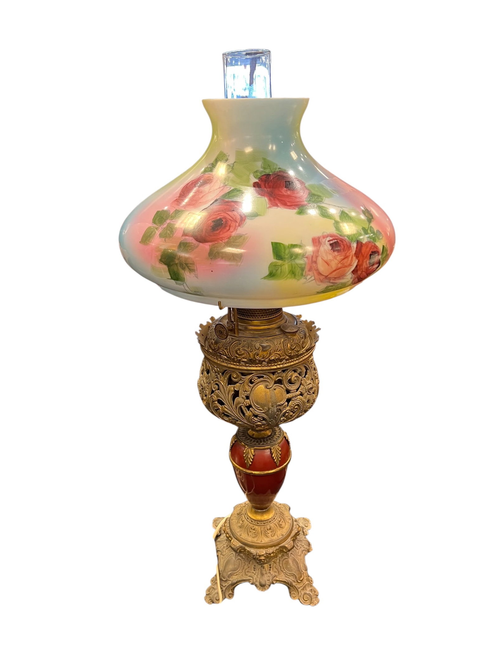 Victorian Style Table Lamp: This is a Victorian "Gone with the Wind" style table lamp featuring a hand-painted glass shade with red roses and an ornate brass base. [1, 2, 3]Design Style: This type of lamp is commonly referred to