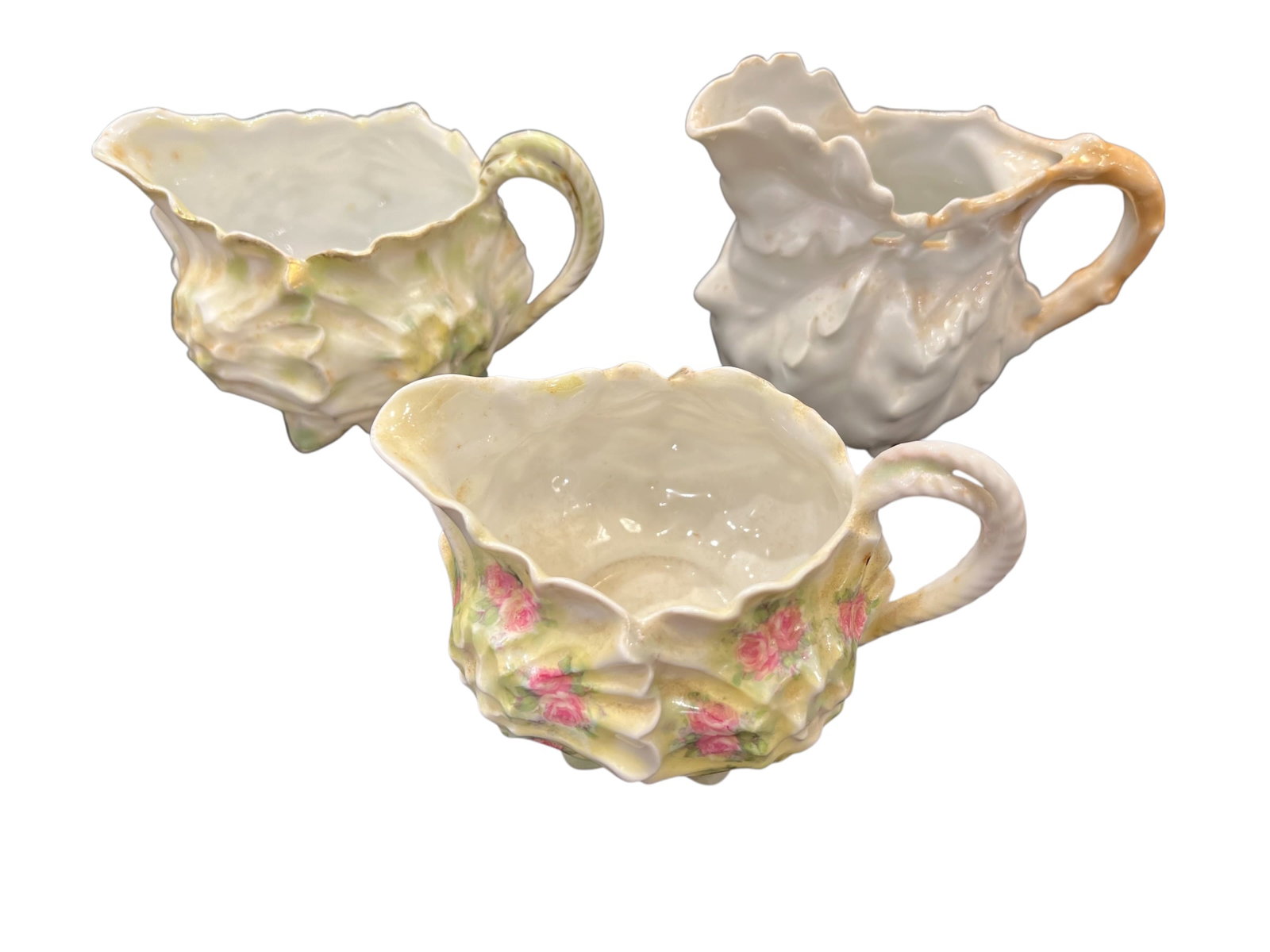 Lot of 3 Royal Bayreuth China Pitchers: These are vintage or antique Royal Bayreuth porcelain pitchers, often found in patterns like grape or with floral decorations and lustrous glazes. [1, 2, 3]Royal Bayreuth: The pitchers are attributed