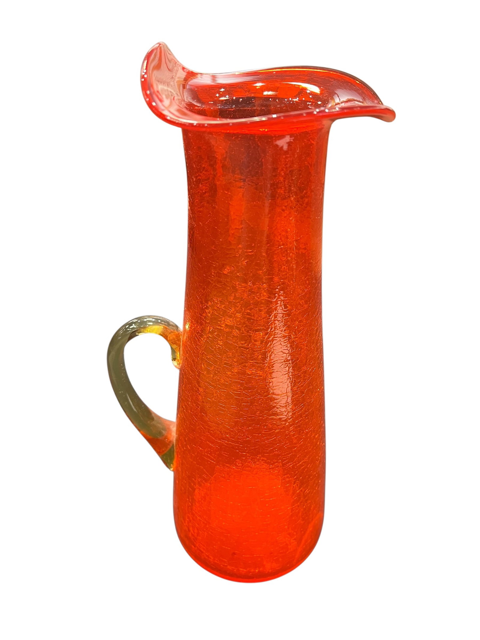 vintage Blenko tangerine crackle glass pitcher: This is a vintage Blenko tangerine crackle glass pitcher. [1, 2]Design Details: It features a vibrant orange to yellow ombre color scheme with a distinct "crackle" texture throughout the glass and a h