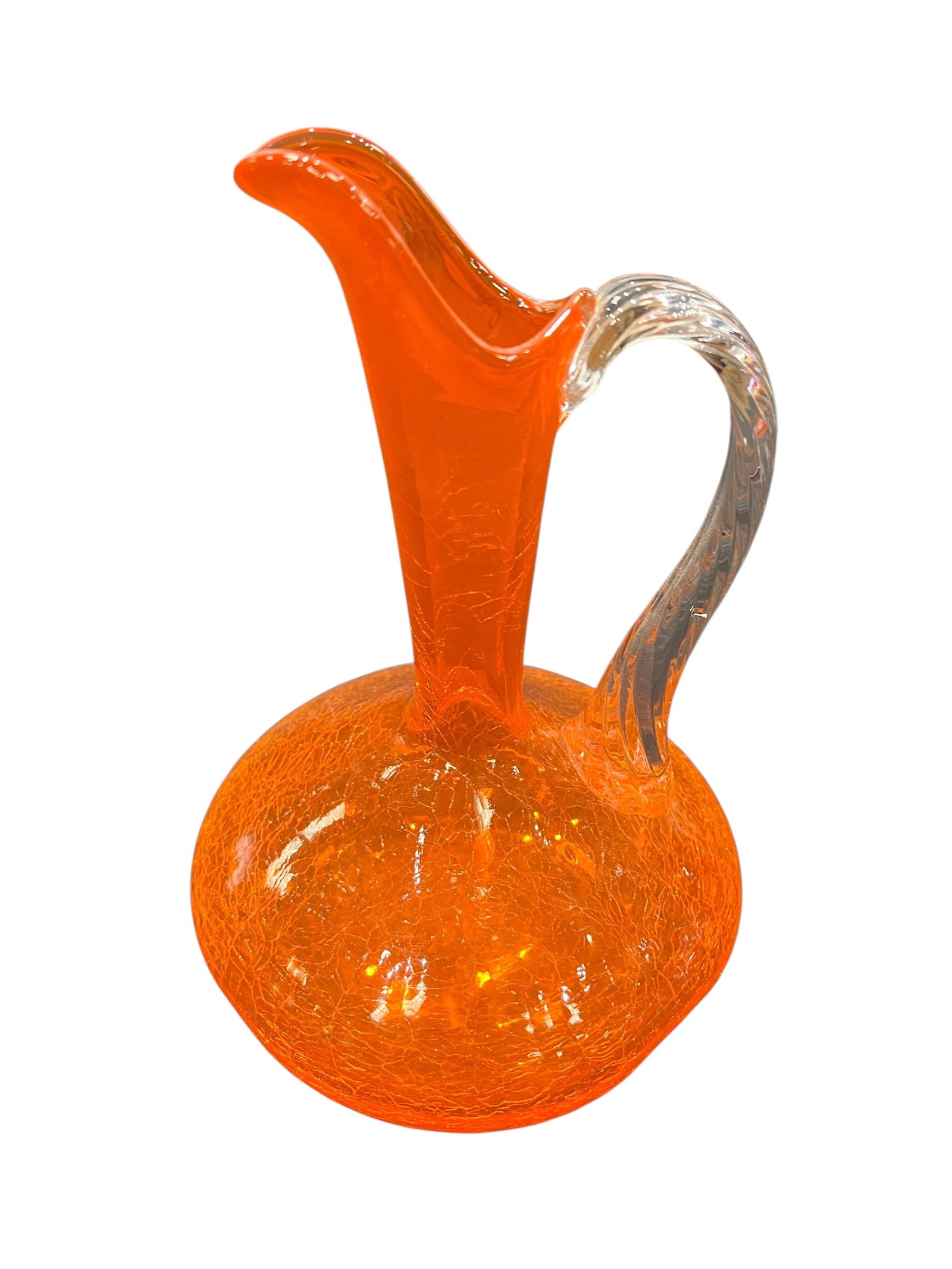 vintage crackle glass pitcher: This is a vintage crackle glass pitcher in orange and yellow, likely hand-blown.Design Style: The piece features a crackled texture on the body and an applied handle.Color Profile: It is often referre