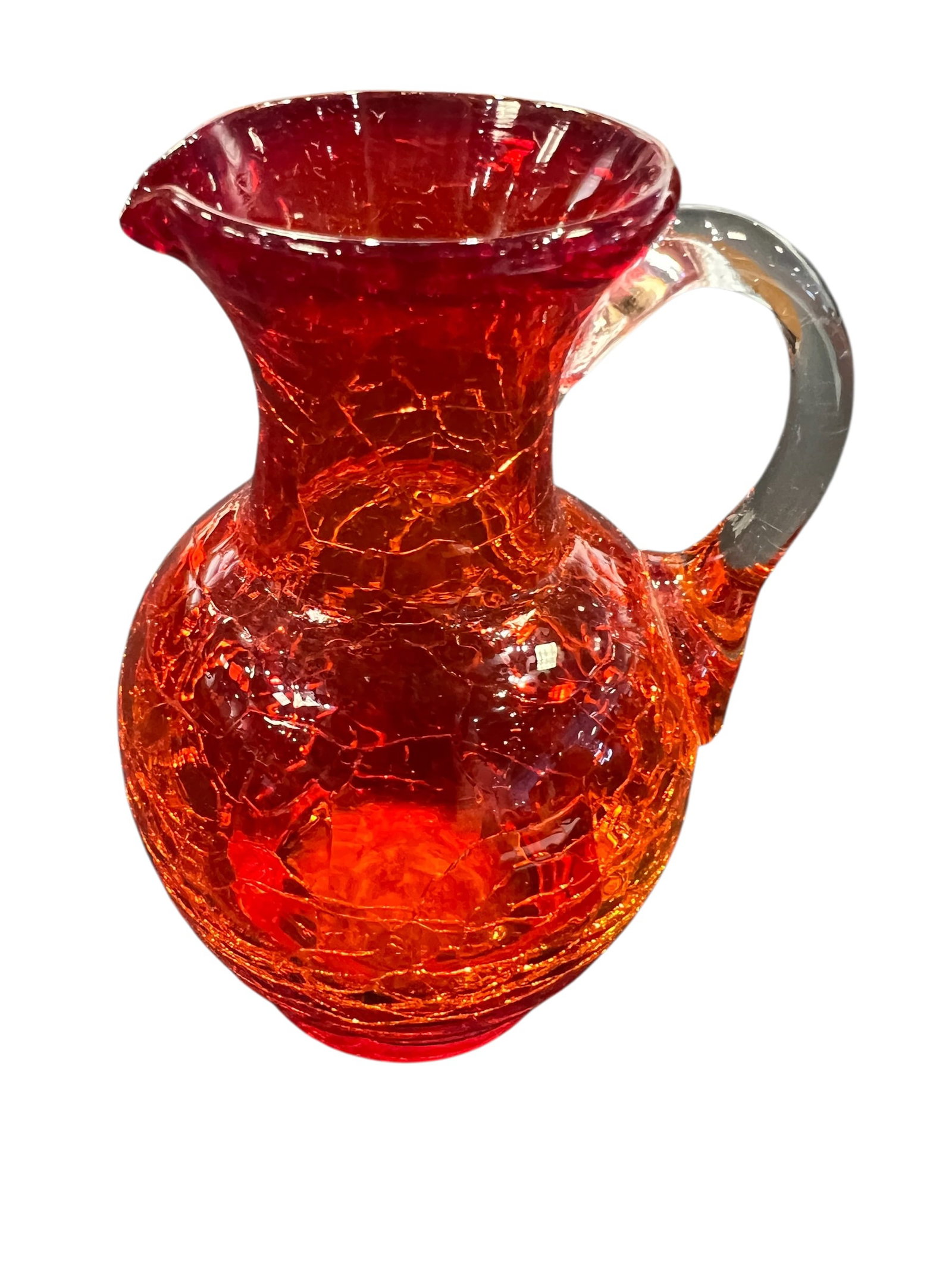 vintage Pilgrim Glass Company Amberina crackle glass pitcher: This is a vintage Pilgrim Glass Company Amberina crackle glass pitcher featuring a vibrant red-to-orange gradient and a clear applied handle. [1, 2]Manufacturing Technique: The unique texture is creat