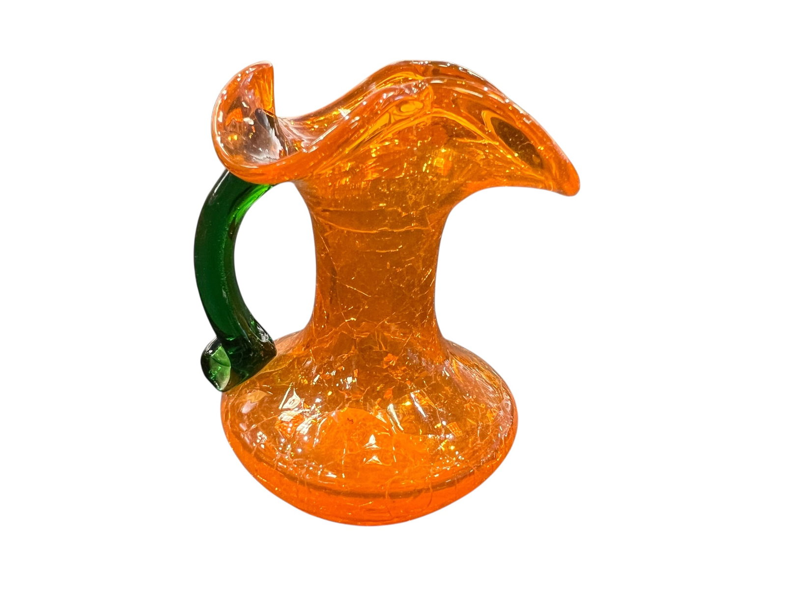vintage Blenko orange crackle glass pitcher: This is a vintage Blenko orange crackle glass pitcher featuring an applied green handle.Manufacturing Technique: The distinctive "crackle" effect is achieved by dipping hot glass into cold water, caus