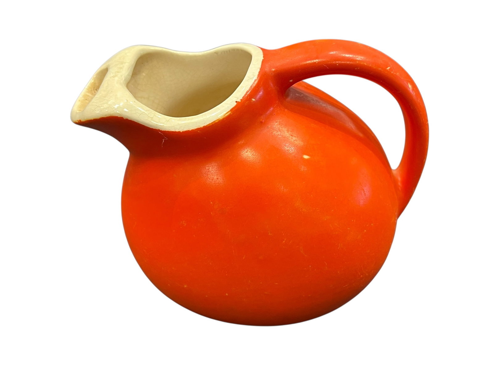 vintage ceramic tilt ball pitcher,: This item is a vintage ceramic tilt ball pitcher, commonly manufactured in the mid-20th century as kitchenware or art pottery. [1, 2]Key CharacteristicsDesign Style: It features a round "ball" or